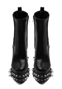 A pair of black leather ankle boots with silver spiked platform soles, shown from a front-facing perspective on a white background.