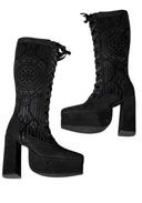 A pair of black lace-up platform boots with high block heels, featuring a detailed gothic-style wing and circular mandala pattern embossed on the shaft.