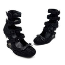 A pair of black wedge sandals with multiple straps and bow details, displayed on a white background with the text 'Dolly Bae' above them.