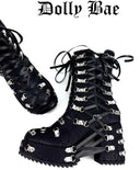Black lace-up boots with metal accents on a white background, featuring the brand 'Dolly Bae'.