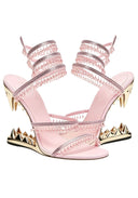 A pair of light pink strappy high-heeled sandals featuring metallic gold spikes, rhinestone-embellished straps, and gold stiletto heels, shown against a plain white background.