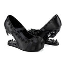 Black gothic Mary Jane heels with spiked heels, bow details, and lace-up fronts, shown against a white background with the text 'Dolly Bae' above.
