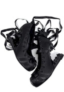 A pair of black gothic-style platform sandals with long dangling ribbons, shown on a plain white background.