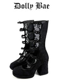 A pair of black lace-up block-heel boots with a textured fabric and sheer lace panels, shown against a plain white background with the text 'Dolly Bae' above them.