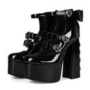 Black patent leather platform ankle boots with high block heels, multiple buckle straps, and silver-tone heart-shaped metal hardware, shown on a white background.