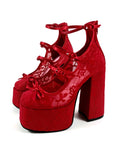A pair of red platform high-heeled shoes with lace-up ankle straps and bow details, shown on a white background with the text 'Dolly Bae' above them.