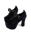 Pair of black clogs on a white background