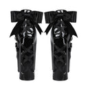 A pair of black platform high heels with wide satin bows and criss-cross lace-up detailing on the sides, shown from the back against a white background.