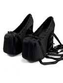 Black ballet shoes with ribbons on a white background, featuring the brand 'Dolly Bae'.