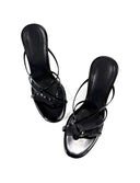 A pair of black strappy thong sandals with studded straps, shown from a top-down perspective on a white background with the brand name 'Dolly Bae' printed in a black gothic font above.