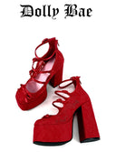 A pair of red platform high heels with lace-up front straps and a chunky block heel, shown on a plain white background with the text 'Dolly Bae' above them.