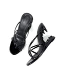 A pair of black patent leather strappy mule sandals with a chunky platform heel, shown from a top-down view on a white background with 'Dolly Bae' text at the top.