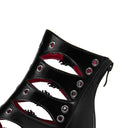 Black high-heeled shoe with red interior and silver eyelets on a white background