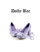 Pair of lavender high heels with ribbons on a white background, featuring the brand 'Dolly Bae'.