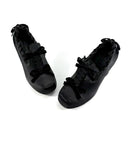 A pair of black patent leather lace-up shoes with decorative bows, displayed on a clean white background with the brand name 'Dolly Bae' printed in a gothic font above them.