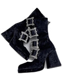 Black velvet ankle boots with silver gothic-style square hardware, shown on a white background with the 'Dolly Bae' brand name printed above.