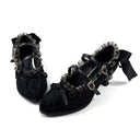 A pair of black lace-up Gothic Mary Jane shoes with ruffled trim, gold-tone hardware, and ribbon bows, displayed on a white background with the text 'Dolly Bae' above them.