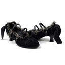 A pair of black lace and velvet gothic-style high heels with silver chain and ring embellishments, displayed on a white background with the brand name 'Dolly Bae' printed above.