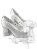 A pair of white lace-up high heels with large bow details and a block heel, shown on a white background with the text 'Dolly Bae' above them.