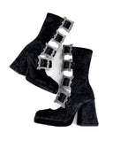 Black velvet ankle boots with silver gothic-style rectangular embellishments, shown on a white background with the brand name 'Dolly Bae' printed above.