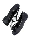 A pair of black leather gothic-style shoes with silver studs and lace-up front details, shown on a white background with the text 'Dolly Bae' in a gothic font above them.