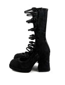A pair of black lace-up ankle boots with a unique skeletal hand design along the front, set against a plain white background with the brand name 'Dolly Bae' printed in a gothic font at the top.