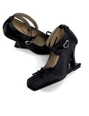 A pair of black Mary Jane-style heeled shoes with ankle straps and small heart-shaped buckle details, shown on a plain white background with the text 'Dolly Bae' above them.