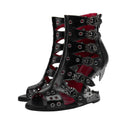 Black high-heeled shoes with red interior and intricate design on a white background