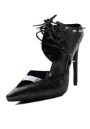A black stiletto pump with a woven texture, pointed toe, lace-up ankle straps, and silver metal studs, shown on a white background.