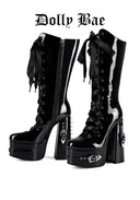 A pair of glossy black platform knee-high boots with high stiletto heels, side zippers, and multiple black ribbon laces, shown on a white background with the text 'Dolly Bae' at the top.